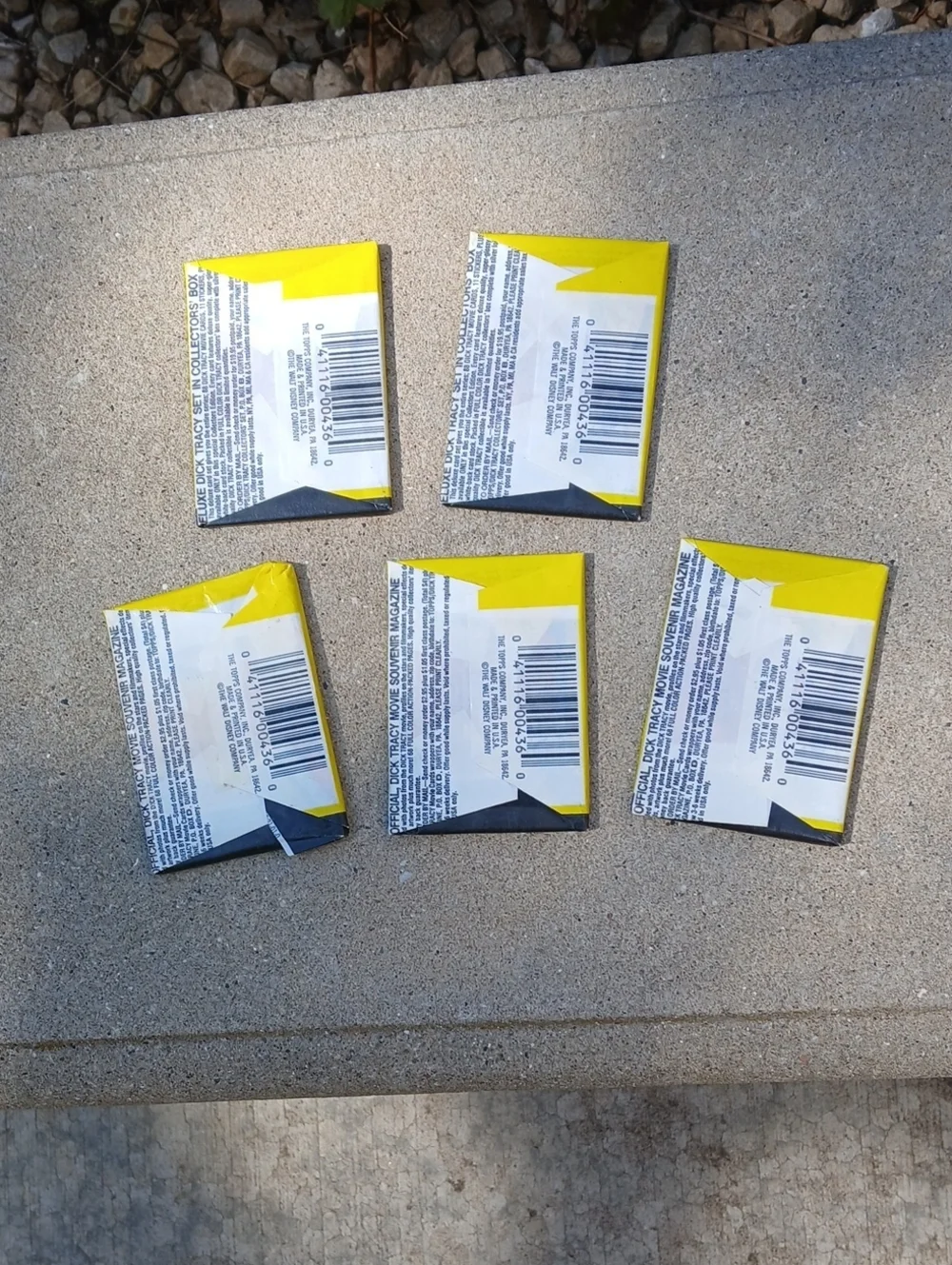 five unopened packs of 1990 Topps Dick Tracy movie trading cards.